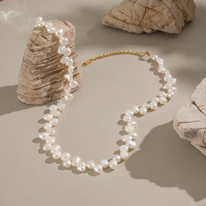 Elegant baroque freshwater pearl necklace with vintage gold clasp on natural stone