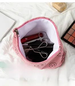 Detailed interior of pink corduroy pouch showing ample storage for makeup brushes