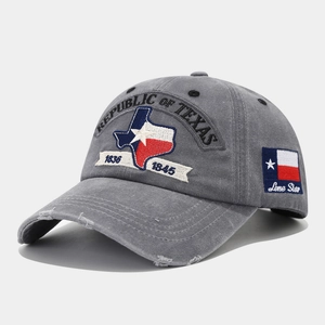 Detail of gray washed cotton baseball cap with Republic of Texas embroidery and distressed brim