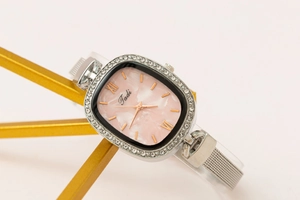 Detailed view of a fashionable women's oval watch with a pink marble dial face