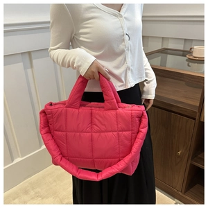 Detailed view of the rose red quilted tote bag showing plush square padded textures