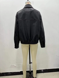 Back view of a black faux leather bomber jacket with elastic hem on a simple mannequin