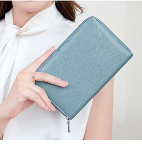 Close-up of blue lychee grain leather wallet with silver zipper held by a model