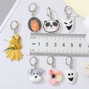 Colorful acrylic ghost animal earrings featuring panda, puppy, and dinosaur shapes with ruler