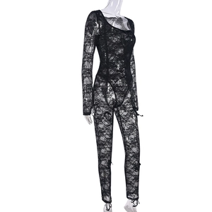Close-up of black lace bodysuit featuring floral embroidery and sheer mesh texture