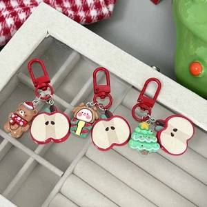 Christmas themed keychains with Santa, bear and tree pendants in a jewelry tray