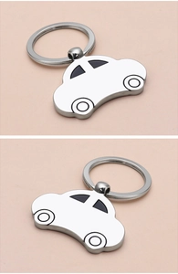 Polished silver car-shaped metal keychain detail with black enamel windows and ring