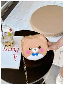 Close-up of a brown cartoon bear crossbody bag for girls with a gold chain strap