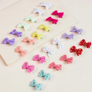 Detailed view of handmade grosgrain ribbon bow hair clips in various bright colors