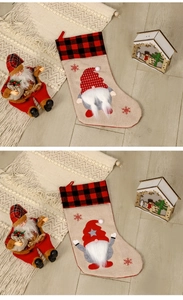Detail of Nordic gnome Christmas stockings on a wooden floor with festive decorations