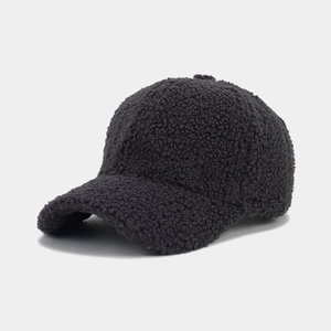 Close-up of thick charcoal grey sherpa fleece texture on a warm baseball cap for winter