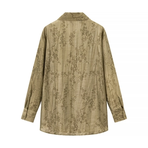 Detailed view of floral jacquard texture on long-sleeved dark olive loose shirt