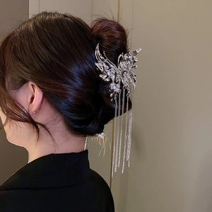 Silver liquid metal butterfly hair claw with long tassel pendants worn on hair