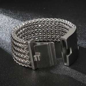 Men's wide stainless steel mesh bracelet with industrial buckle on black texture