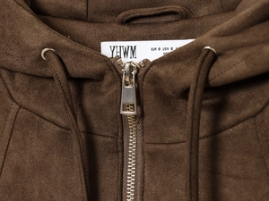 Detailed close-up of zipper and soft suede texture on dark brown hooded bomber jacket