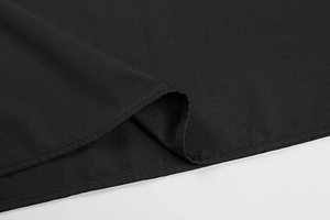 Close-up of black fabric hem with professional stitching on a sleek summer dress