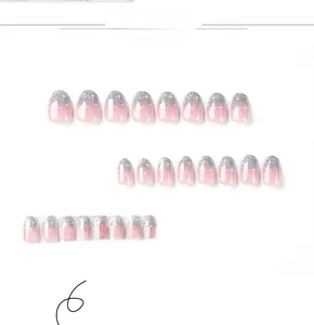 Detail view of 24pcs pink gradient press-on nails with silver glitter and star accents