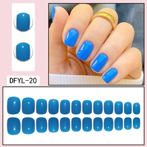 Macro detail of bright blue short square press-on nails set with 24 gloss pieces