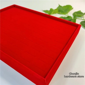 Macro view of 100-slot red velvet jewelry tray for ring and stud earring storage