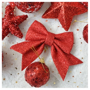 Close-up of red sequined bow and ornaments for Christmas tree decoration
