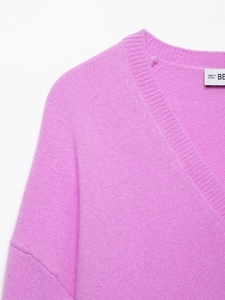 Detail of ribbed V-neckline on soft purple knit sweater with fuzzy fabric texture