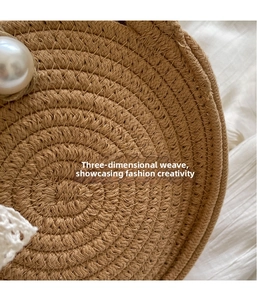 Close-up of hand-woven straw bag texture featuring a large decorative pearl detail