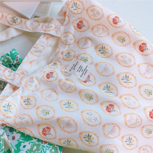 Detailed close-up of floral cotton tote bag featuring vintage butterfly and botanical prints