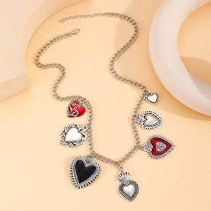 Vintage silver chain necklace featuring multiple heart pendants with colorful enamel details