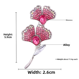 Detail view of pink floral rhinestone brooch with dimensions 5.9cm by 2.6cm