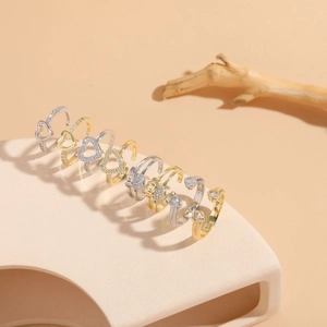Detailed view of adjustable heart rings with zircon pave and AMOR engraving