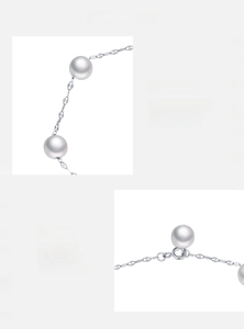 Macro detail of S925 sterling silver chain and lustrous white pearls for women