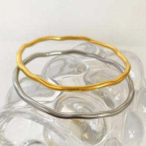 Elegant wavy titanium steel bracelets in gold and silver finish with mirror texture