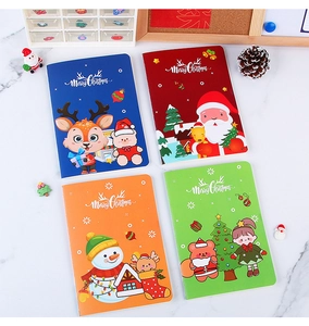 Macro detail of four assorted Christmas A5 notebooks with festive holiday illustrations
