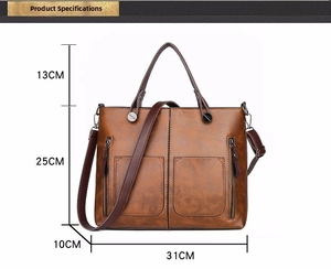 Detailed view of brown vintage tote bag with dimensions 31x25x10cm and dual handles