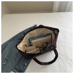 Top-down view of a black cherry print tote bag interior showing its large storage capacity