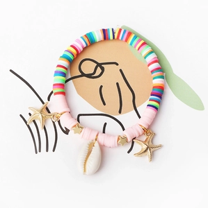 Detail of colorful beads and starfish charms on a bohemian style shell anklet set