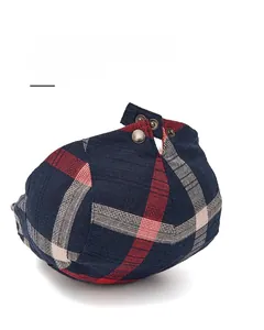 Detail view of adjustable stainless steel brass buckles on classic plaid newsboy cap
