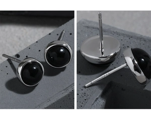 Macro detail of S925 sterling silver studs with round black agate inlay and hallmarking
