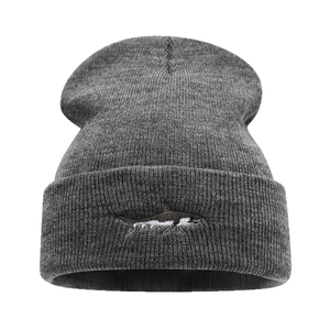 Dark gray knitted beanie with detailed shark embroidery and classic fold-over cuff design
