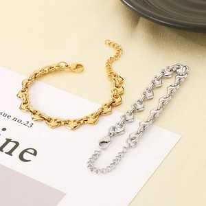 Detail of gold and silver heart link bracelets with lobster clasp and extension chain