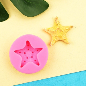 Detailed pink starfish silicone mold for fondant and clay on a bright background