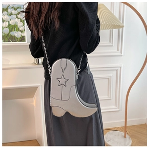 Silver cowboy boot shoulder bag detail with star stitching and fine chain strap