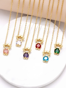 Detailed view of colorful bear-shaped crystal pendants on gold link chains