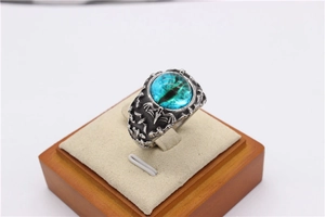 Detailed view of Gothic bat wings and blue dragon eye stone on vintage steel ring