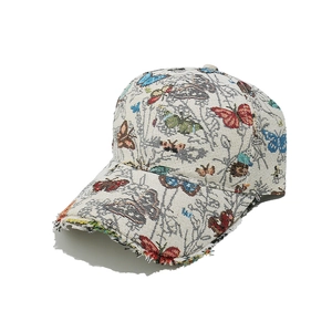 Close-up of jacquard baseball cap featuring butterfly embroidery and frayed brim details