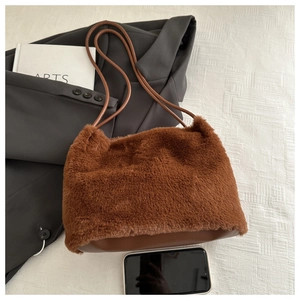 Detail of plush brown tote bag with long straps and soft textured faux fur material