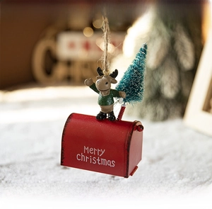 Detail of red metal mailbox Christmas ornament with reindeer, tree and Merry Christmas text