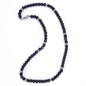 Close-up of black matte beads with blue cat eye stones and silver spacers on white background