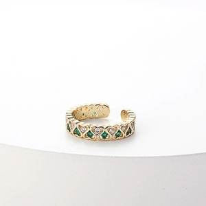 Detail of 14k gold plated heart ring featuring alternating green and clear zircon stones