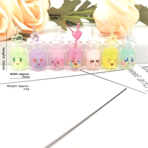 Macro shot of 35mm mini resin bottle charms with heart straws and cute face patterns
